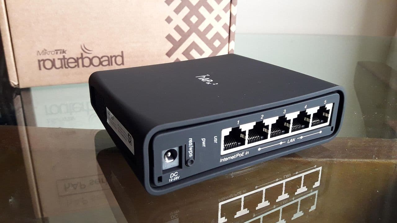 A MikroTik hAP ac2 router with its Ethernet ports facing the camera